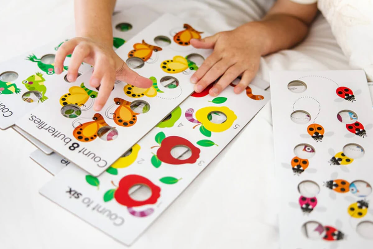 Image of a child having fun playing with Poke-A-Dot Numbers Learning Cards