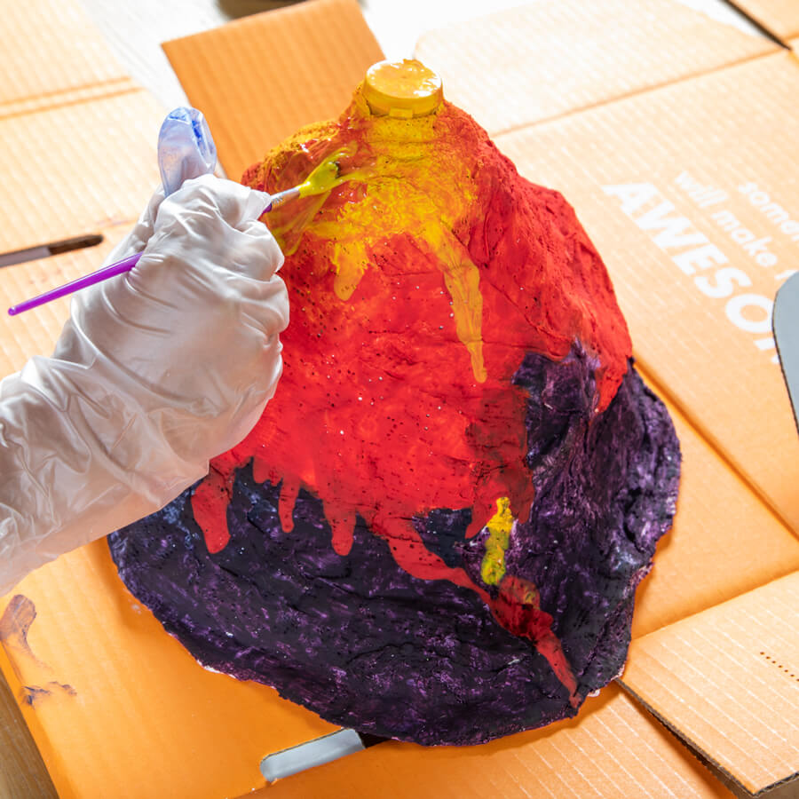 Image of a child having fun playing with Surprise Ride - Build & Paint a Volcano Science Kit!