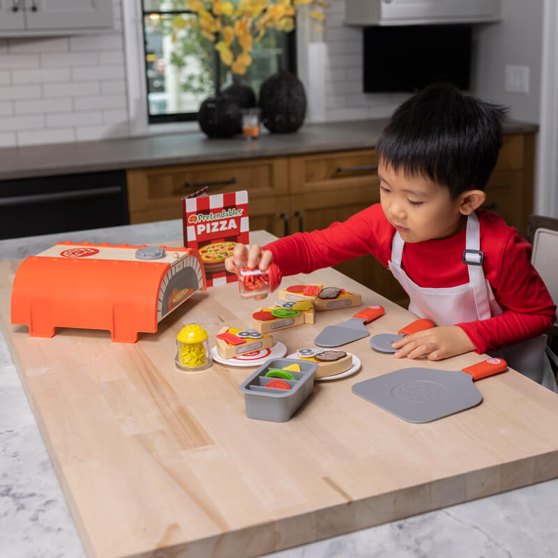 Child having fun playing with Pretendables Backyard Pizza Oven Set!