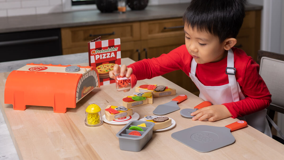 Child having fun playing with Pretendables Backyard Pizza Oven Set!