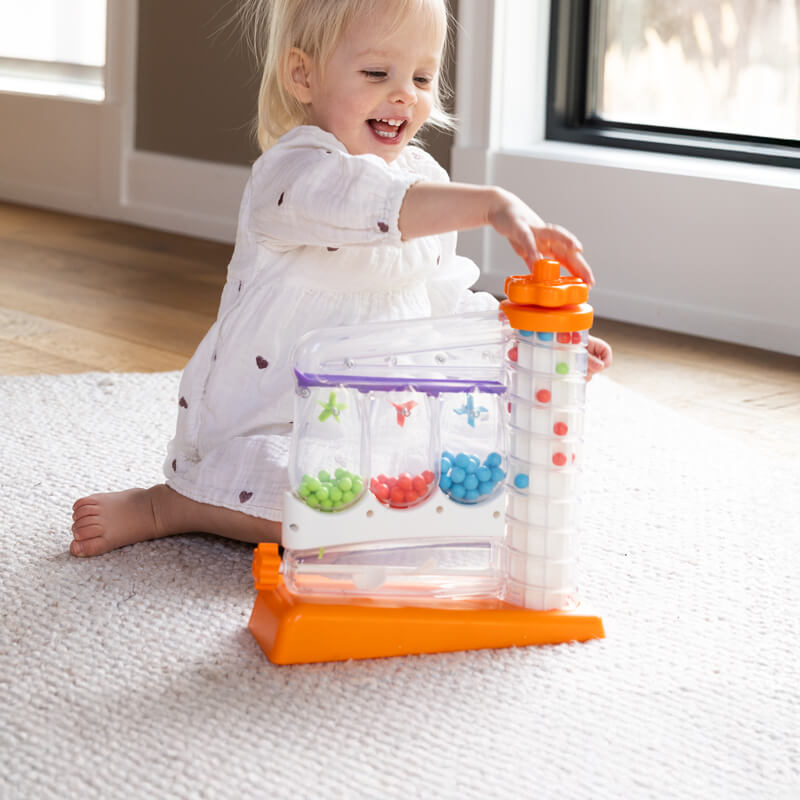 Smiling child sitting by a window playing with SortAgain!