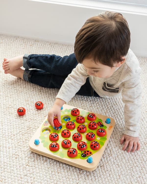 Child playing with Ladybug's Garden Memory Game